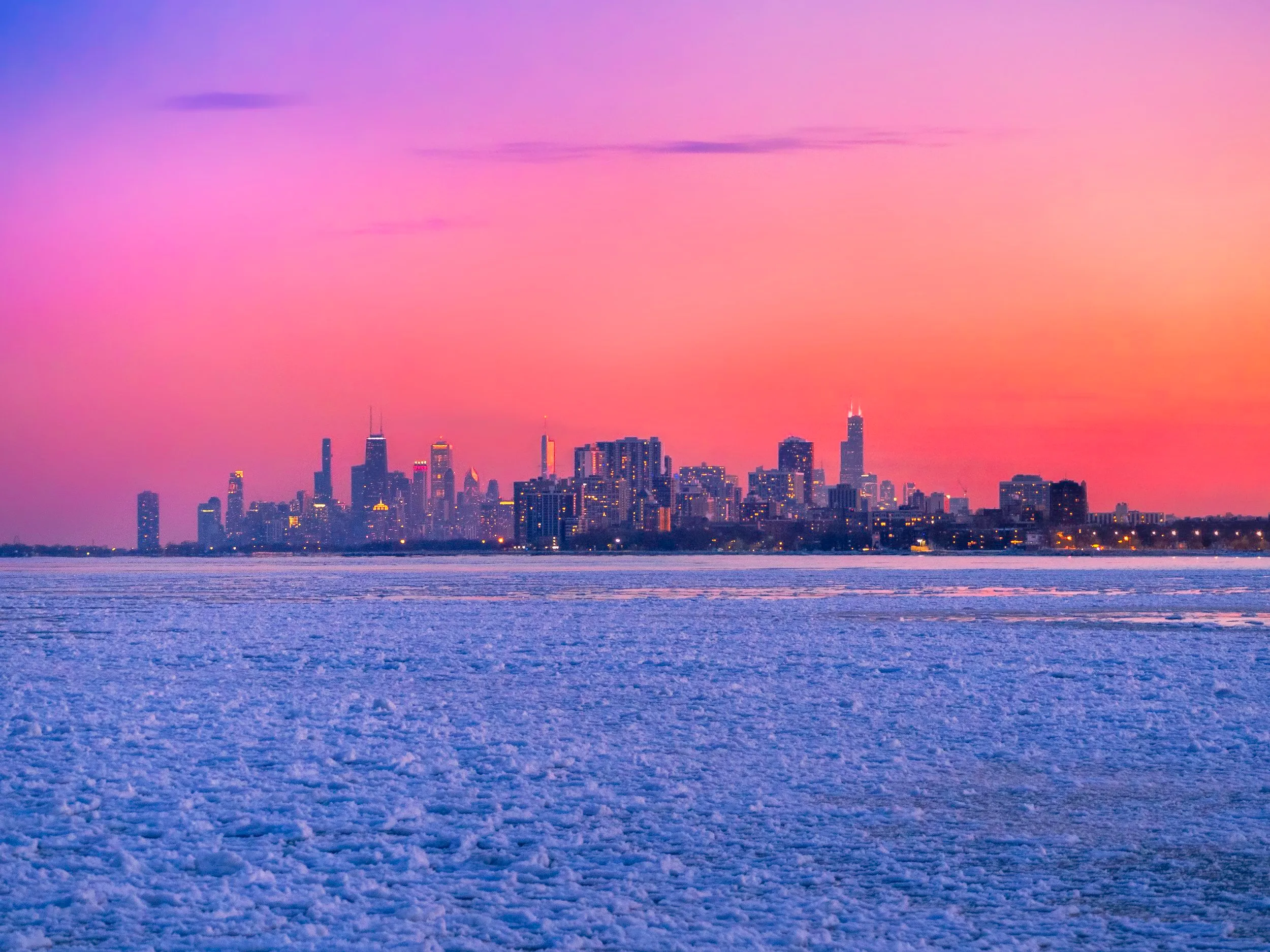 The Chicago skyline at sunset over a frozen Lake Michigan — photograph by Chirag Bachani